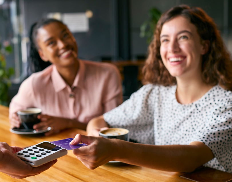 woman-in-coffee-shop-paying-bill-with-contactless-2026-01-05-23-03-47-utc-1-.jpg